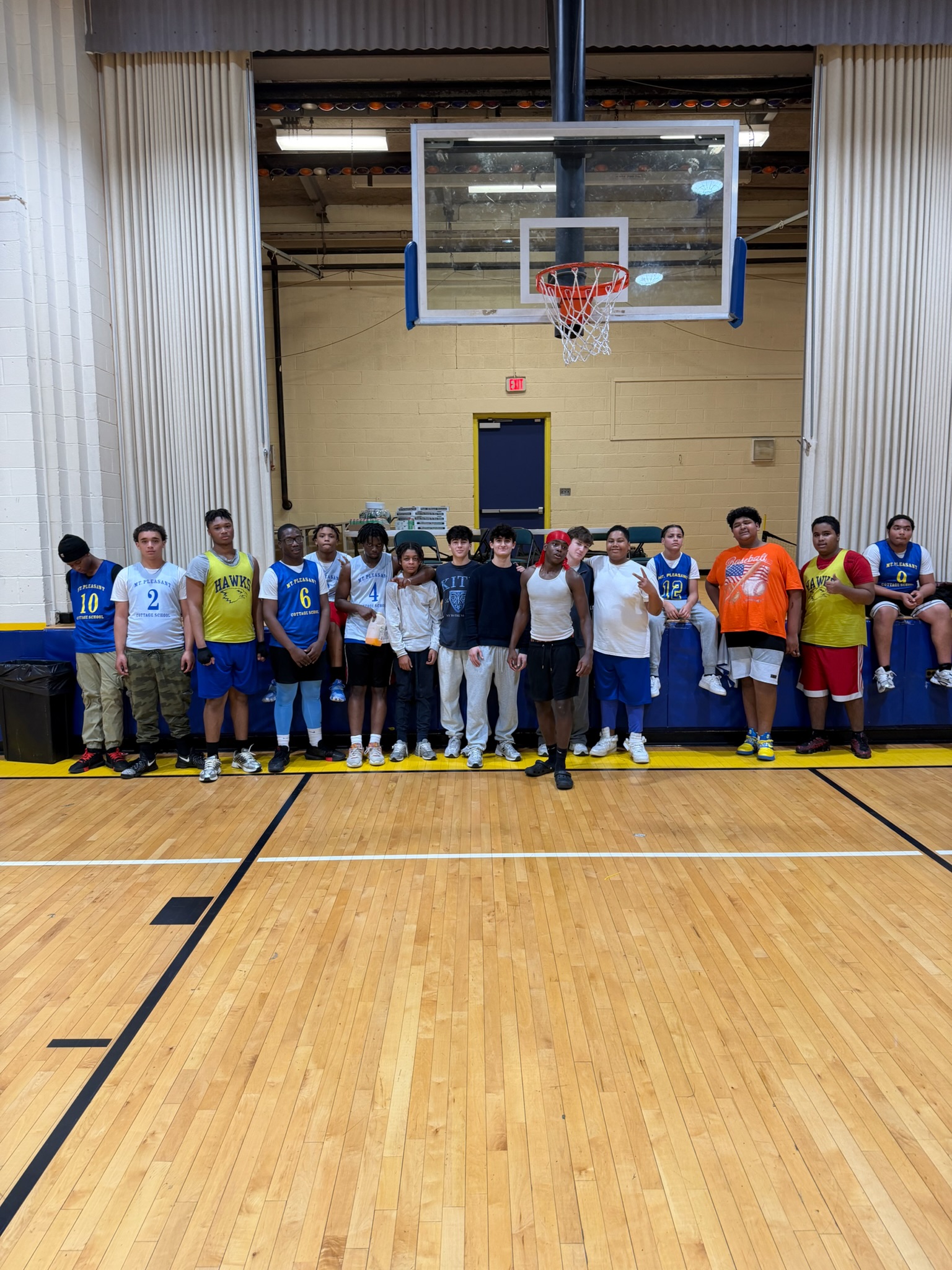 Basketball participants and Hoops for Hope organizers together in the gym